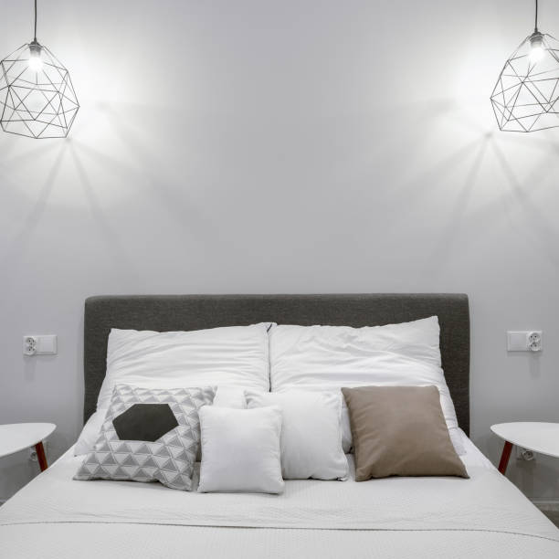 istock Double bed in white bedroom, close-up 1289253780