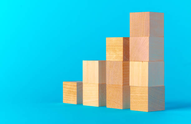 istock Toy wooden blocks on blue background front view 1289254167