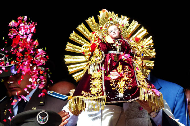 bishop carries the sculpture of niño viajero, ecuador - parade doll child baby imagens e fotografias de stock