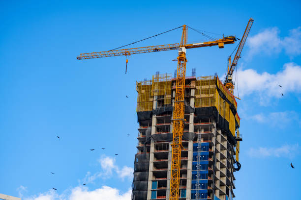 istock Highrise construction building with cranes on blue sky 1289257793