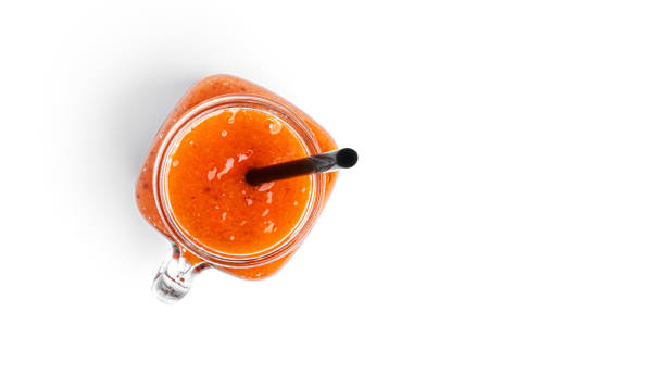 istock Smoothie with persimmon and banana in Mason jar on a white background 1289258228