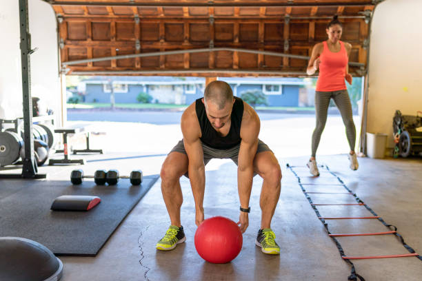 istock Mixed race couple doing cross training HIIT workout in garage 1289259479