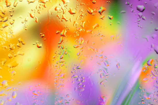 istock Abstract scenic bright background with drops of water, blurred style, selective focus, vivid tints of purple and yellow orange colors 1289261136
