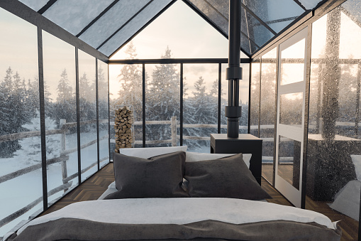 3d rendering of cozy hut with bed and glass panels at snow covered forest