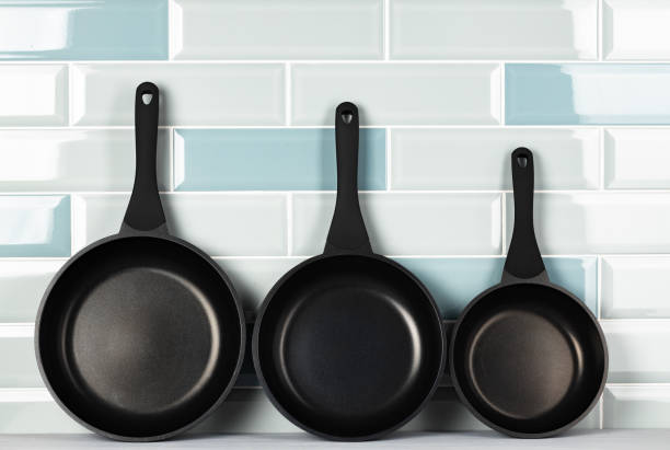 istock New black cookware against blue tile wall 1289262572