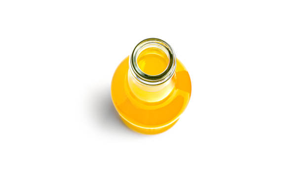 istock Opened bottle of yellow drink on a white background 1289263316