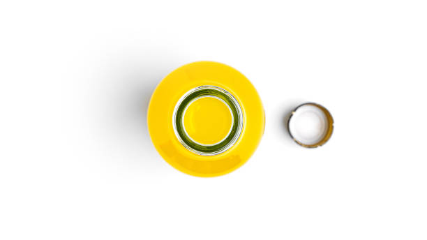 istock Opened bottle of yellow drink on a white background 1289263449