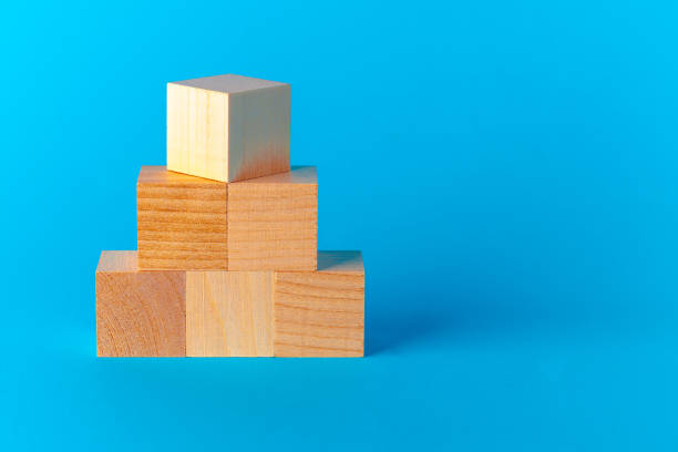 istock Toy wooden blocks on blue background front view 1289263609