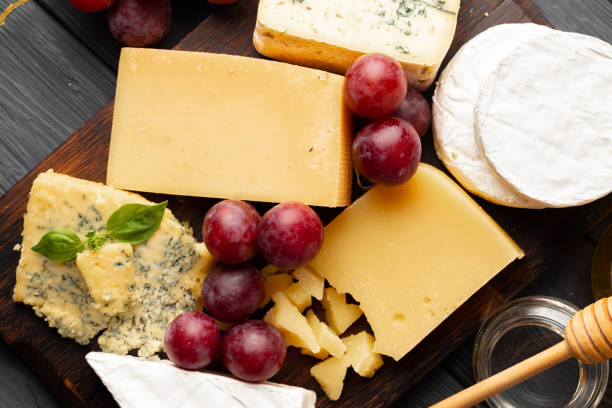 istock Cheese served with grapes and honey on grey surface 1289265174