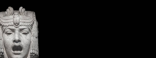 Banner with ancient Egyptian woman as a mask, either singing or crying, with open mouth at black background with copy space.