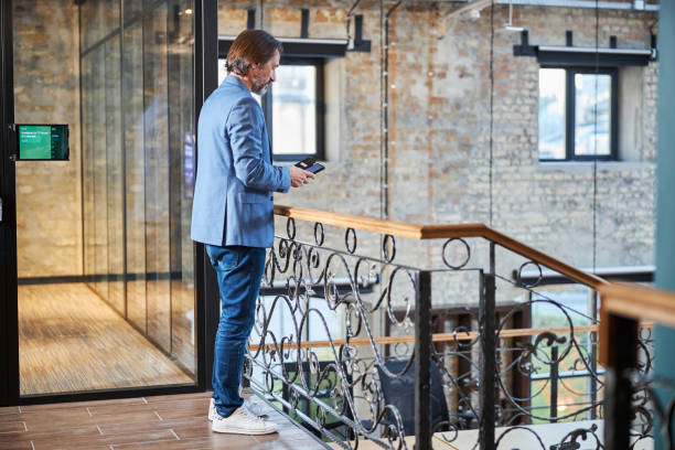 istock Hotel resident quickly checking his phone updates 1289272126