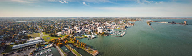 Incredible aerial city skyline panorama photograph of Sandusky, Ohio from the shoreline of the bay in Lake Erie with parks and harbors seen below on a sunny day. Incredible aerial city skyline panorama photograph of Sandusky, Ohio from the shoreline of the bay in Lake Erie with parks and harbors seen below on a sunny day. lake erie stock pictures, royalty-free photos & images