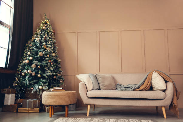 istock Christmas studio interior with decorated Christmas tree, gift boxes and cozy couch. New year and Christmas photo studio 1289272333