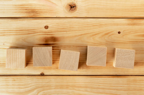 groupped wooden square blocks on dark wooden table - groupped imagens e fotografias de stock