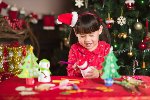 istock young girl making Christmas craft at home 1289272636