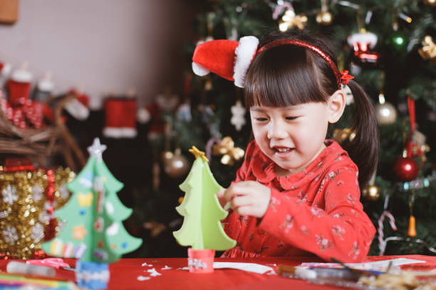 istock young girl making Christmas craft at home 1289273143