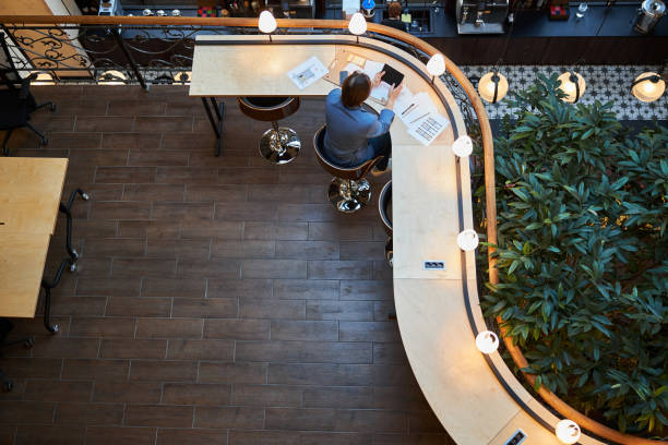 istock Lonesome businessman using his laptop at coworking space 1289273335