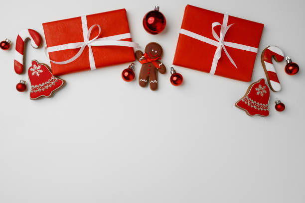 istock Red gift boxes and Christmas baubles on white background 1289273444