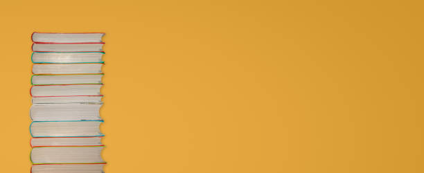 istock Tall stack of colorful books at gradient yellow background with copy space for text. Concept education and learning. 1289273757
