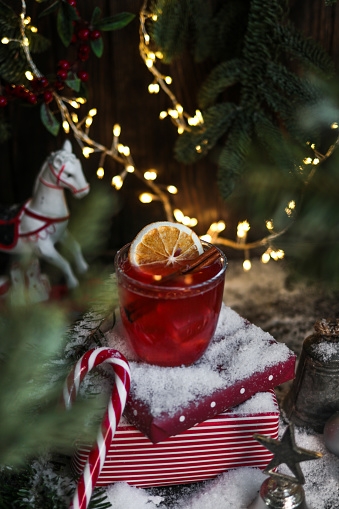 Red Sangria with oranges, pomegranate seeds, cranberry, rosemary and spices - homemade festive drink mulled wine for Christmas time.