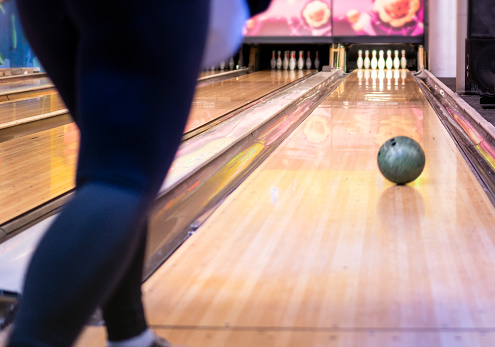 Unrecognizable young woman Playing Bowling. Horizontal composition.