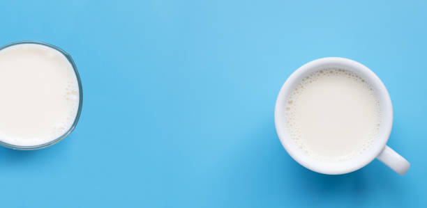 istock Glass with cup of milk on blue background. Copy space 1289274790