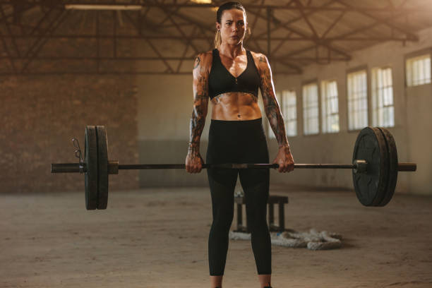 istock Woman doing deadlift workout with barbell 1289274837