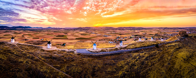 Panoramic aerial view of Consuegra windmills at sunset. Castilla La Mancha, Spain