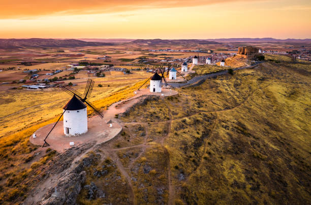 Consuegra windmills at sunset. Castilla La Mancha, Spain aerial view of traditional medieval spanish windmills in Consuegra at sunset. Castilla La Mancha, Spain plateau concept stock pictures, royalty-free photos & images