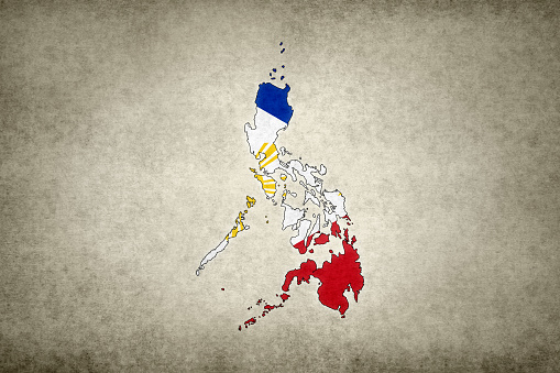 Grunge map of the Philippines with its flag printed within its border on an old paper.