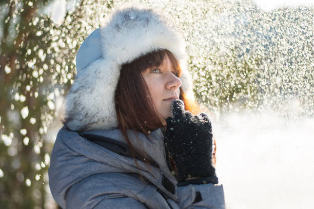 istock Young woman stands in snowy forest. 1289277005