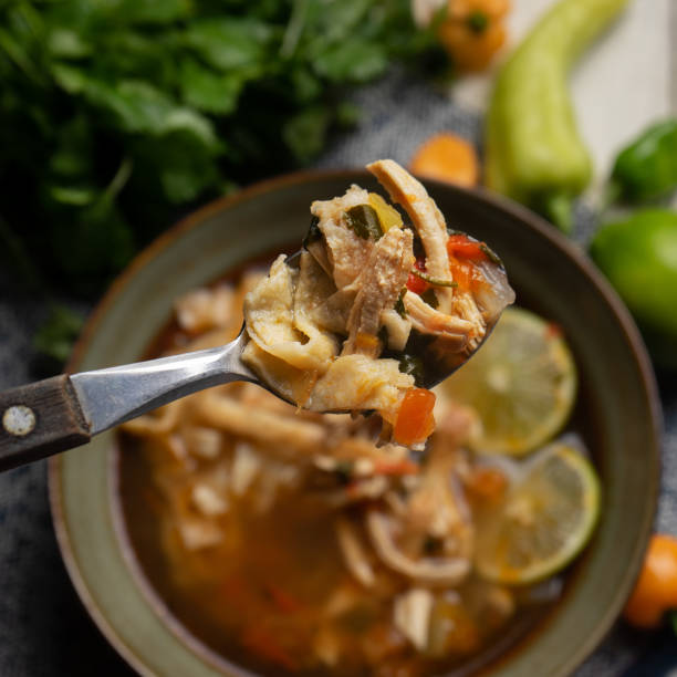 Mexican lime soup with chicken on white background