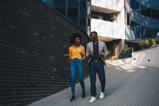 istock Young African American couple talking, walking. 1289279491