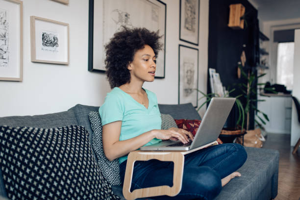 istock Young woman working online at her improvised home office 1289280520