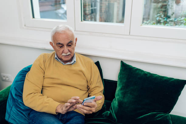 istock Senior man relaxing at home and using smartphone 1289280556