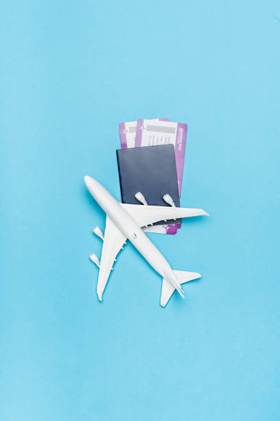 istock top view of white plane model and tickets on blue background 1289281727