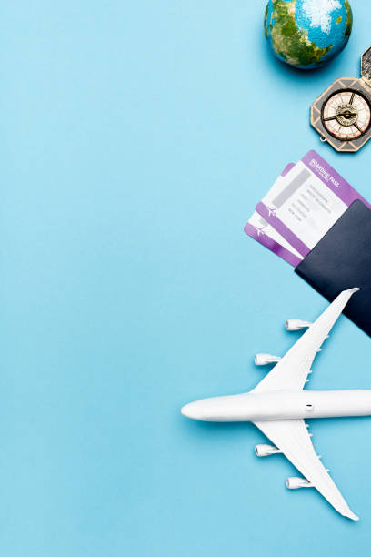 istock top view of white plane model, compass, globe and tickets on blue background 1289281737