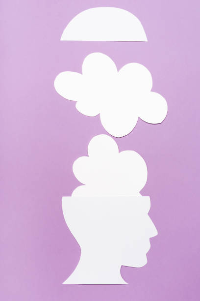 istock top view of paper human head and clouds on violet background 1289281738