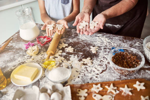 istock Chef and sous-chef making gingerbread men out of dough 1289283814