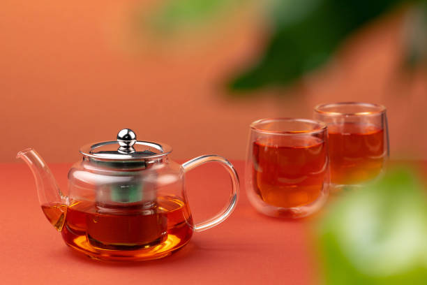 istock Glass teapot and two glass cups with tea 1289284022