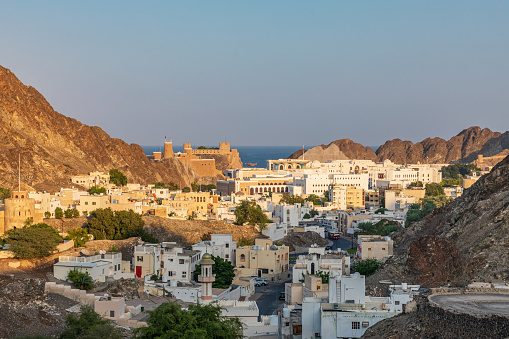 Middle East, Arabian Peninsula, Oman, Muscat. Sunset view of a neighborhood in the hills of Muscat.
