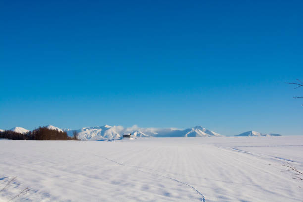 istock Snowfields and snowy mountains with a blue sky 1289286237