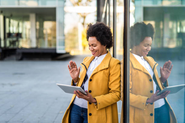 istock Young African American businesswoman using a digital tablet outdoors for a video call. 1289287906