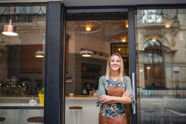 istock Smiling Blonde Argentine Cafe Owner at Front Door 1289288890