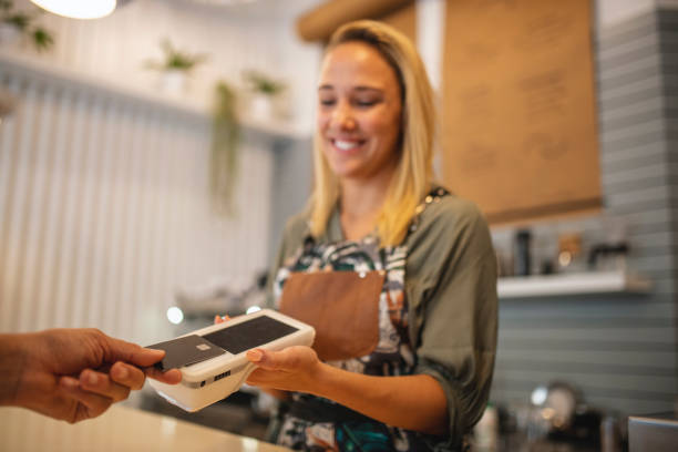 istock Close-Up of Customer Making Mobile Payment at Cafe 1289288906