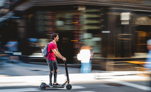 istock Male Backpacker Riding Electric Push Scooter in Buenos Aires 1289288929