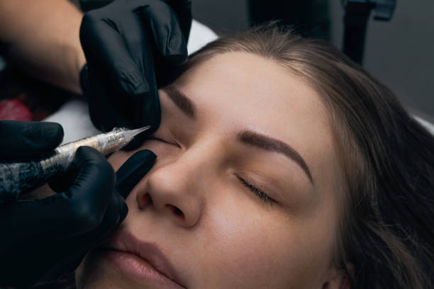 istock Permanent eyebrow makeup procedure. Eyebrow tattooing, process. The use of tools by a master for permanent eyebrow makeup. 1289289003