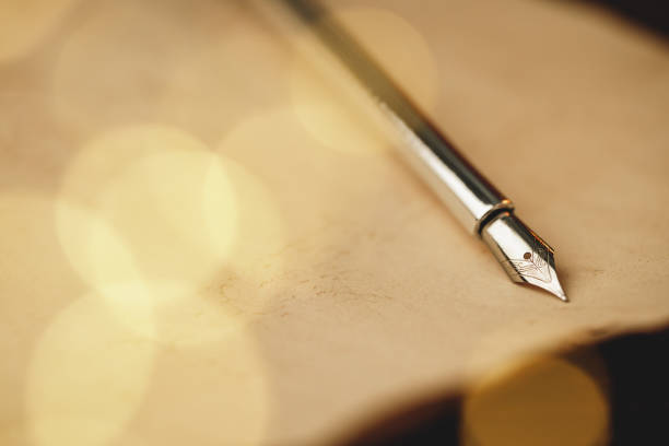 Feather fountain pen on weathered paper close up vintage style