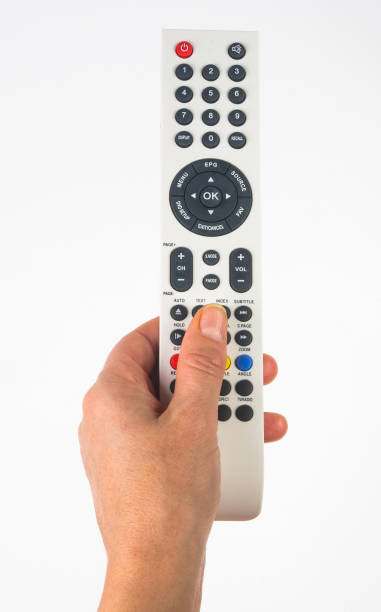 istock hand holding a remote control on white background, close-up 1289293763