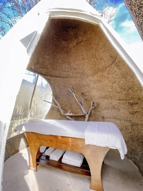 Inside an outside drop shape structure made in cork at spa Aqua village Portugal design outdoors spa with thermal water treatment massage table in a sunny day photography - fotografia de stock